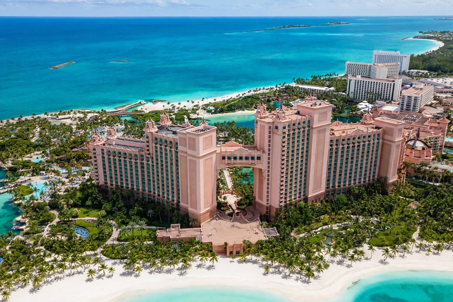 The iconic pink Royal towers of Atlantis Paradise Island fronting white sand beaches