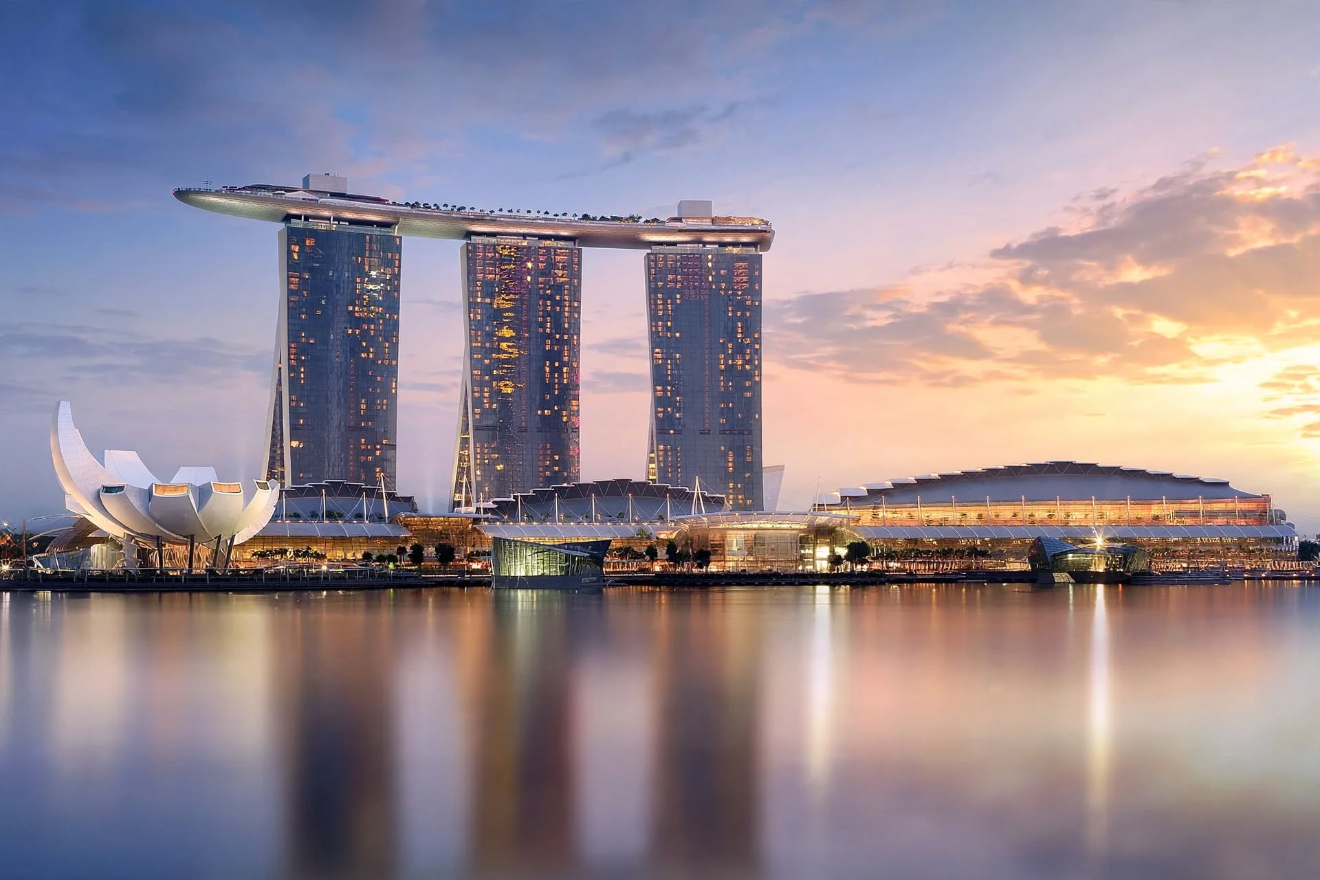 Iconic three-tower structure and cantilevered SkyPark of Marina Bay Sands at dawn